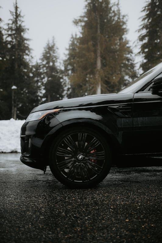 Black Range Rover Sport luxury SUV on road